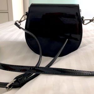 Faux patent leather black mini saddle purse.